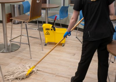 a cleaning professional mopping a tile floor