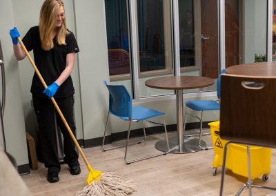 a cleaning professional mopping a floor