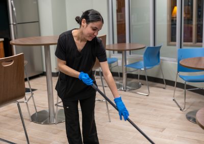 a cleaning professional sweeping the floor