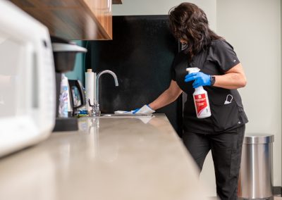 a cleaning professional whiping down a counter top